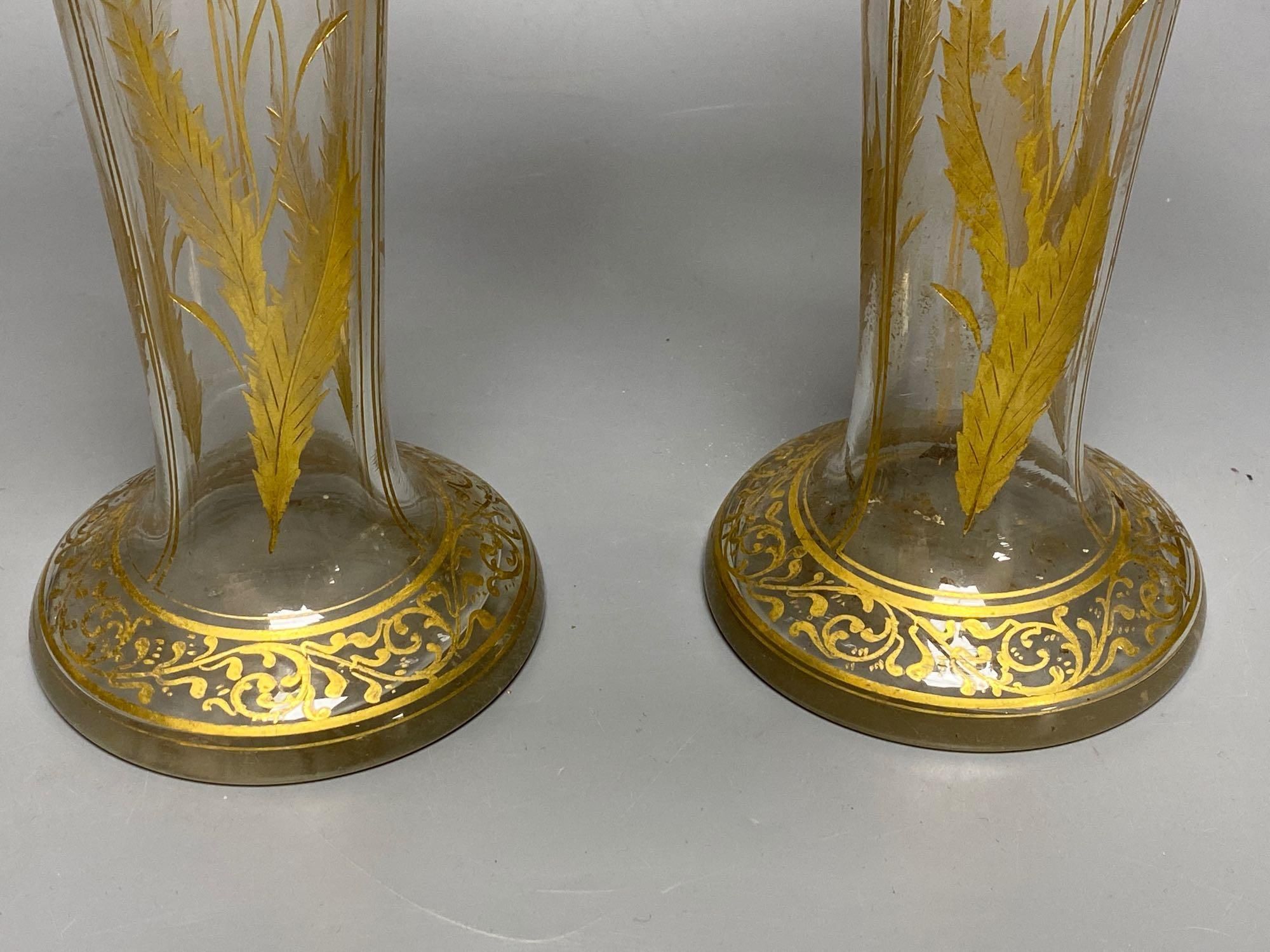 A pair of Bohemian gilt painted and blue flash cut trumpet shaped glass vases, 26cm